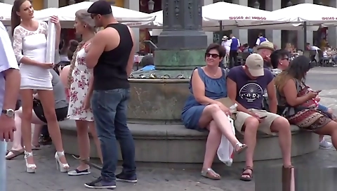 Horny slave in public streets with a group of horny dudes